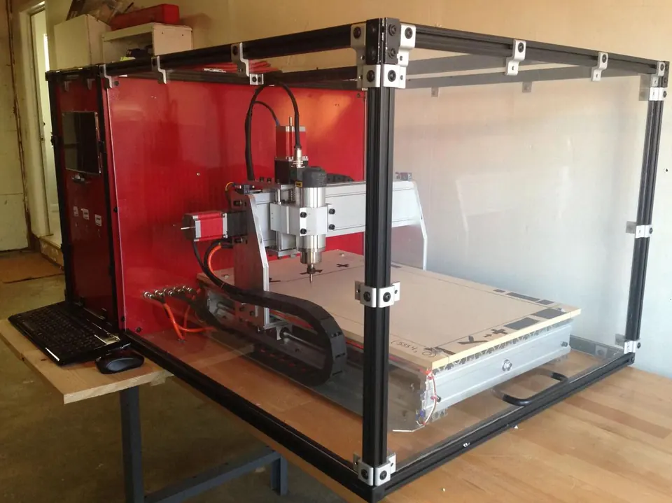 Desktop CNC router machine in a red-and-black enclosure